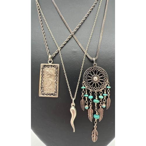 1006 - 3 silver and white metal pendants on silver chains. A Dream catcher pendant with turquoise beads on ... 