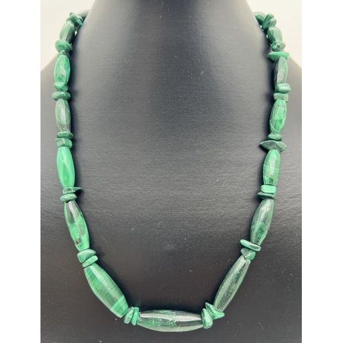 1009 - A 20 inch Malachite graduating oval bead and chip necklace with sterling silver spring ring clasp.