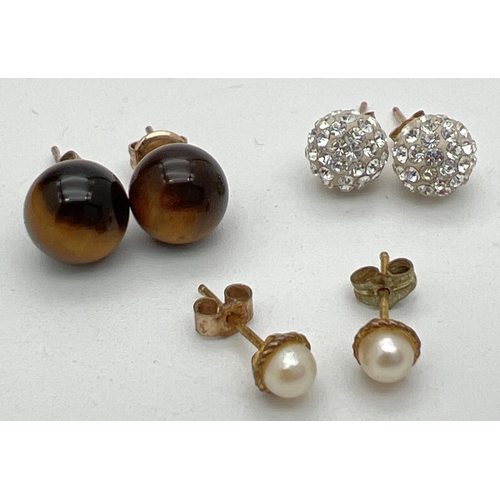 1012 - 3 pairs of 9ct gold and yellow metal stud style earrings. Tigers eye, crystal studded balls and smal... 