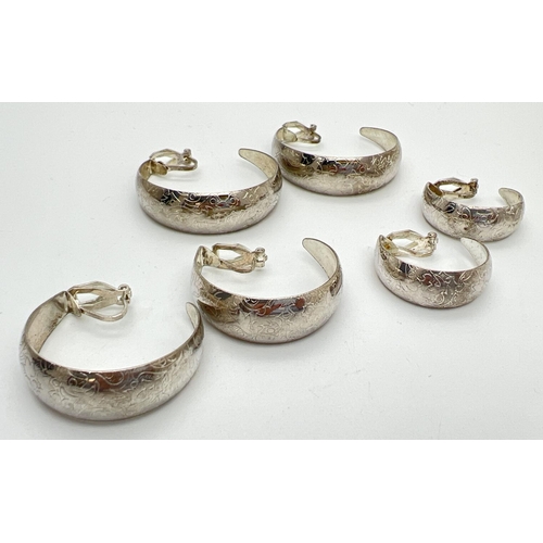 1019 - 3 pairs of vintage, graduating, white metal, clip on half hoop earrings with floral pattern. Largest... 