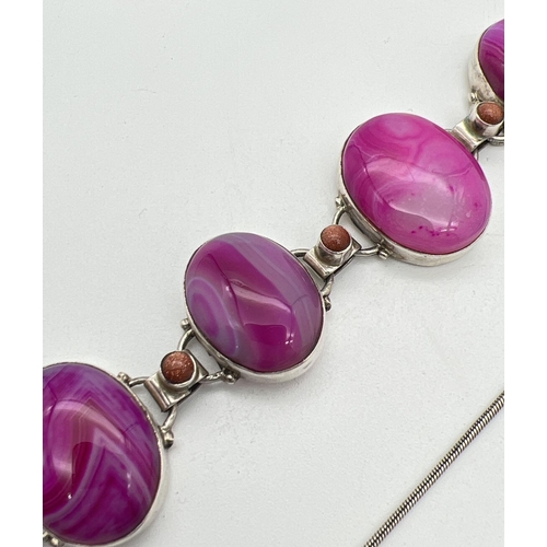 1038 - A matching set of silver and pink dyed agate jewellery. A pair of oval drop earrings, an oval panel ... 