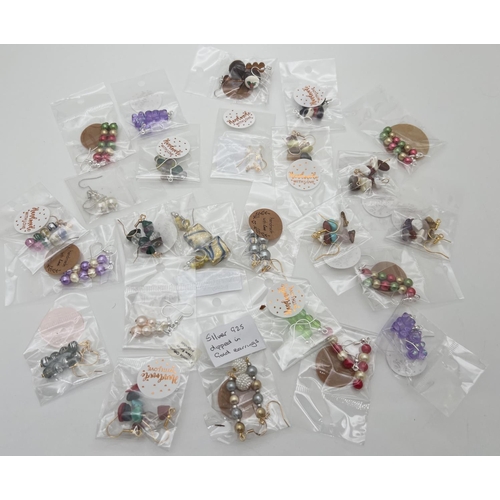 1045 - 25 pairs of handmade drop style earrings, all in original packets. To include foil glass, novelty an... 