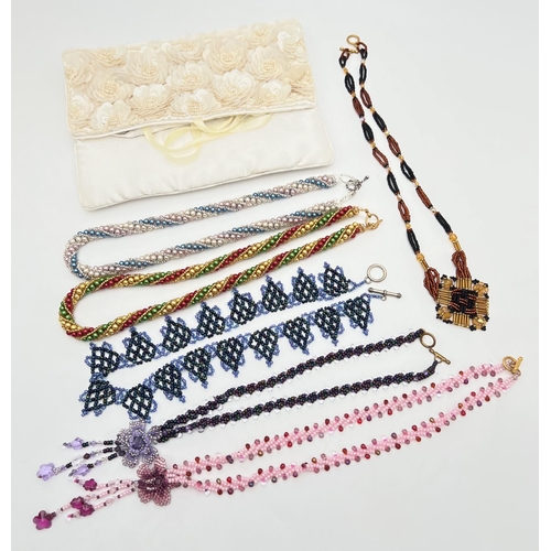 1046 - A cream satin beaded jewellery roll with 6 handmade faux pearl and glass bead necklaces. In various ... 