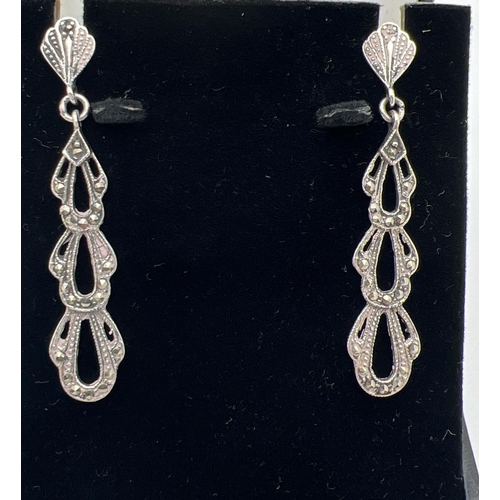 1047 - A boxed pair of Art Nouveau style silver drop earrings set with marcasite stones. Total drop approx.... 