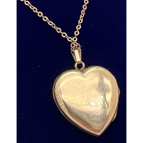 1059 - A vintage 9ct gold front and back heart shaped locket with half floral engraving to front. On a 17 i... 