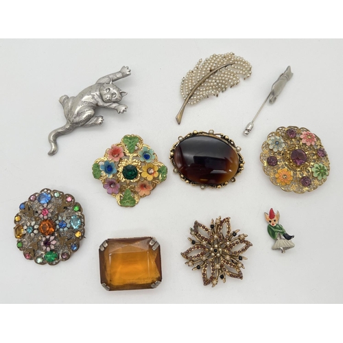 1063 - A collection of 10 vintage brooches and pins. To include faux pearl leaf design, stone set floral ci... 