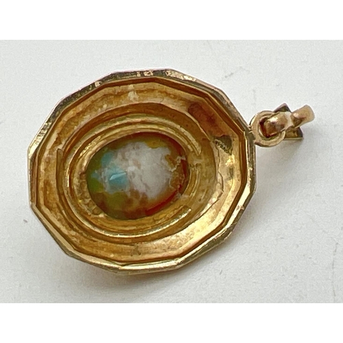 1066 - A vintage 9ct gold oval shaped pendant set with a turquoise cabochon. Gold marks to back of pendant.... 