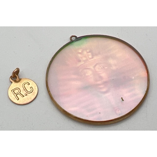 1067 - 2 gold pendants. A large circular Pharaoh holographic glass pendant in a gold surround, together wit... 