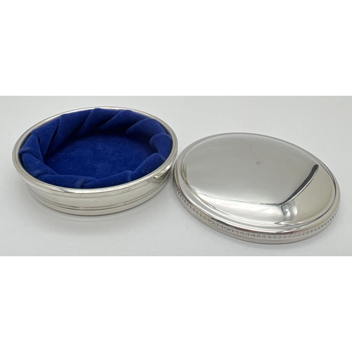 1150 - A round pewter lidded trinket box by Tiffany & Co.  with beaded decoration to edge of lid. Blue velv... 