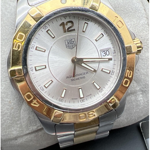 1134 - A boxed Aquaracer wristwatch WAF1120 by Tag Heuer. Stainless steel strap in silver and gold tones. B... 