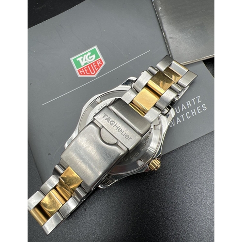 1134 - A boxed Aquaracer wristwatch WAF1120 by Tag Heuer. Stainless steel strap in silver and gold tones. B... 