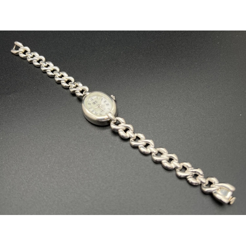 1136 - A ladies sterling silver quartz wristwatch by Carvel. Twist design link bracelet strap with extra li... 