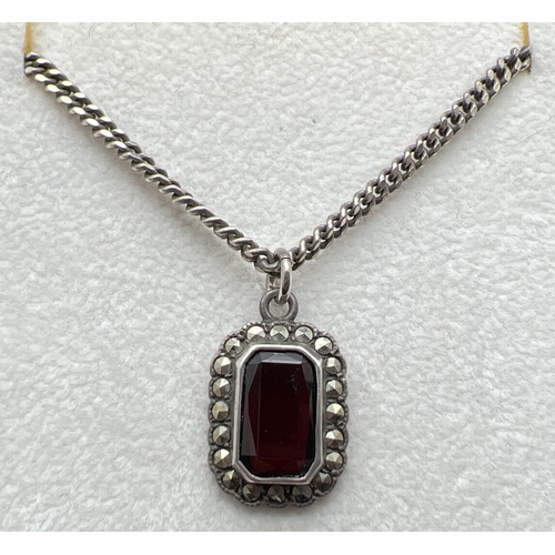 1085 - A vintage silver pendant necklace, a baguette cut garnet surrounded by marcasites, on an 18