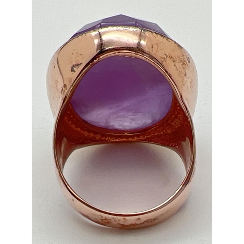 1086 - A silver cocktail statement ring in rose gold finish, set with a large oval checker board cut amethy... 