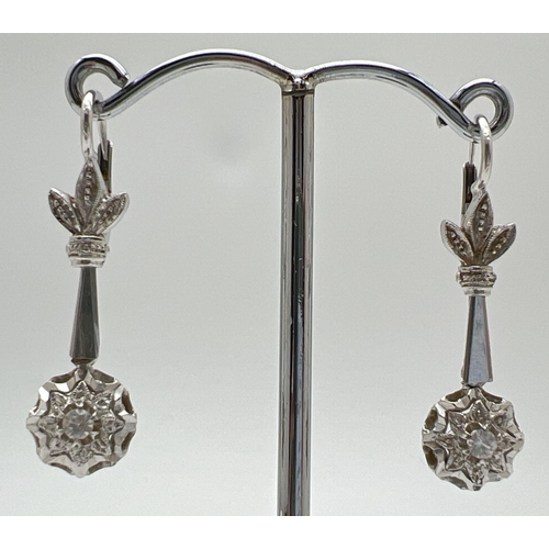 1088 - A pair of vintage 18ct white gold drop earrings set with a single round cut clear topaz stone to eac... 