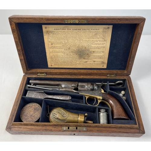 1210 - An antique 1851 U.S.A. .36 Navy Colt pistol with original box and accessories. Wooden grips with bra...