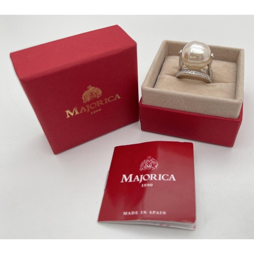 1106 - A boxed sterling silver Majorica pearl statement/cocktail ring with certificate. Large central white... 