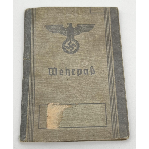 1222 - A World War II Wehrpass conscript registration book Auiguist Folksdorf with identity photo. Stamped ... 