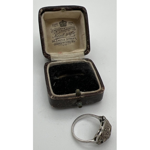 1110 - An Art Deco silver dress ring set with marcasites - central stone missing, in a period Kent & Co jew... 