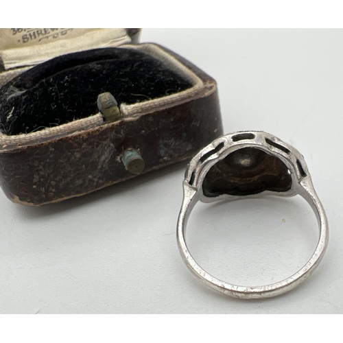 1110 - An Art Deco silver dress ring set with marcasites - central stone missing, in a period Kent & Co jew... 