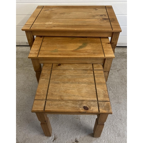 1497 - A modern pine nest of 3 tables with channelled detail to tops. Largest approx. 53.5cm tall x 66cm lo... 