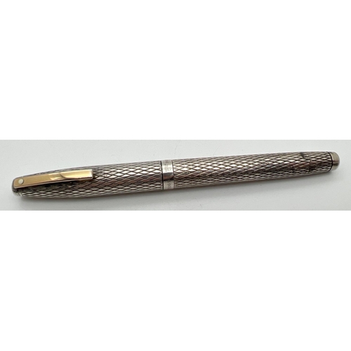 1180 - A vintage sterling silver cased Sheaffer fountain pen with 14k gold nib. Engraved criss-cross design... 