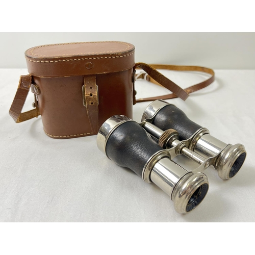 1336 - A leather cased set of vintage Le Jockey Club extending binoculars in chrome and black leather finis... 