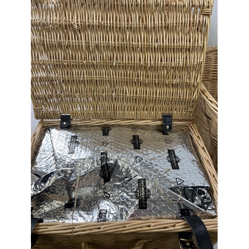 1418 - 3 wicker items. A lined picnic basket with carry handle containing cutlery and cruet set, an oval wa... 