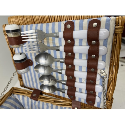 1418 - 3 wicker items. A lined picnic basket with carry handle containing cutlery and cruet set, an oval wa... 