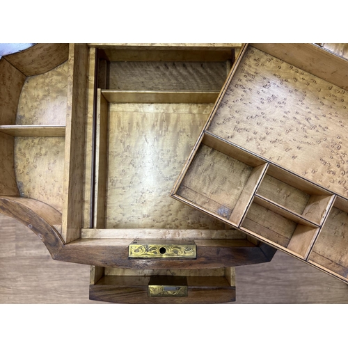 1499 - A Victorian walnut veneer sewing box on shaped and turned legs with ceramic castors. Lift up lid wit... 