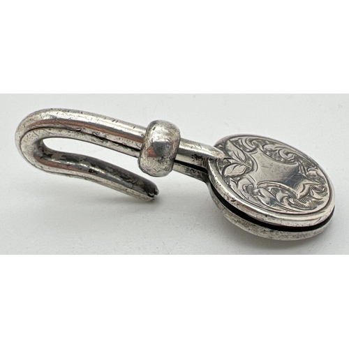 1157 - A Victorian silver napkin hook with engraved detail to circular clip. Decorative scroll & foliate de... 