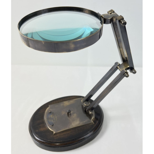 1422 - A large desktop magnifying glass with hinged folding stand with oval plaque for Watts & Sons Ltd, on... 