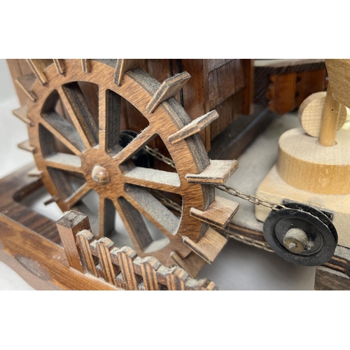 1254 - A wooden chalet style flour mill Cuckoo clock with pine cone weights by Schneider. Musical movement ... 