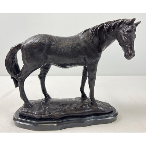 1192 - A bronze figure of a horse mounted on a black marble base. Approx. 22cm tall x 26cm long.