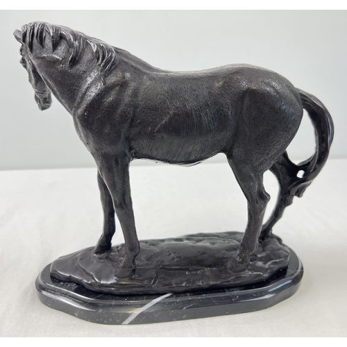 1192 - A bronze figure of a horse mounted on a black marble base. Approx. 22cm tall x 26cm long.