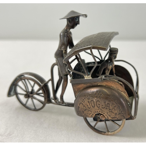 1194 - A small brass model of a rickshaw with hammered detail to mudguards and shade and moving rear wheel.... 