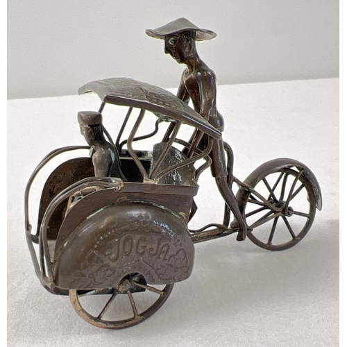 1194 - A small brass model of a rickshaw with hammered detail to mudguards and shade and moving rear wheel.... 