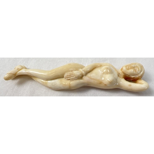 1425 - A small carved nude figure with polished finish, possibly bone. Approx. 13cm long.