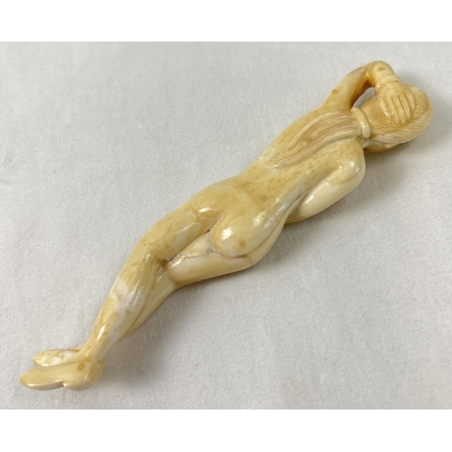 1425 - A small carved nude figure with polished finish, possibly bone. Approx. 13cm long.