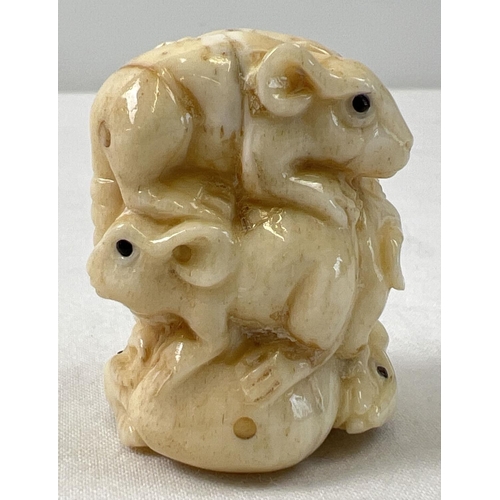 1312 - A small carved netsuke modelled as a stack of mice with polished finish and signature to underside. ... 