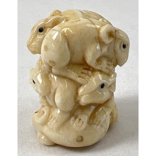 1312 - A small carved netsuke modelled as a stack of mice with polished finish and signature to underside. ... 