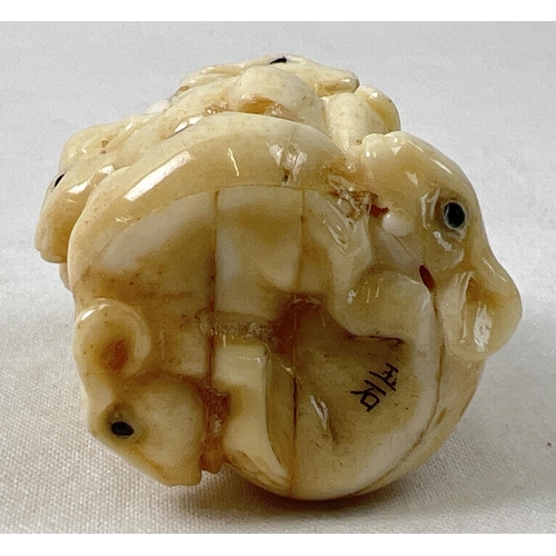 1312 - A small carved netsuke modelled as a stack of mice with polished finish and signature to underside. ... 