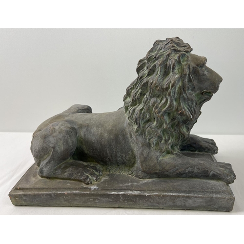 1271 - A large stoneware figure of a seated lion on a rectangular tile base, with a bronzed effect painted ... 