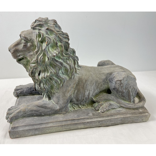 1271 - A large stoneware figure of a seated lion on a rectangular tile base, with a bronzed effect painted ... 