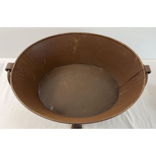 1198 - A small oval shaped metal fire pit with 4 claw feet, looped handles and rusted finish. Approx. 24cm ... 