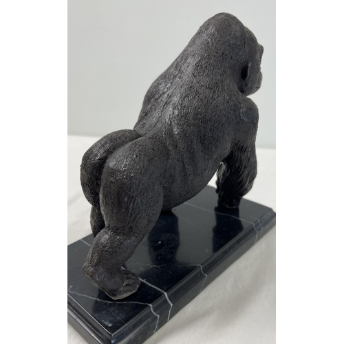 1199 - A bronze figure of a gorilla mounted on a black marble rectangular shaped base. Approx. 17cm tall x ... 