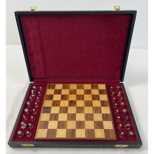 1162 - A cased silver chess set with silver and silver gilt playing pieces and a wooden chessboard. Each pi... 