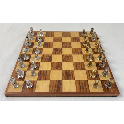 1162 - A cased silver chess set with silver and silver gilt playing pieces and a wooden chessboard. Each pi... 