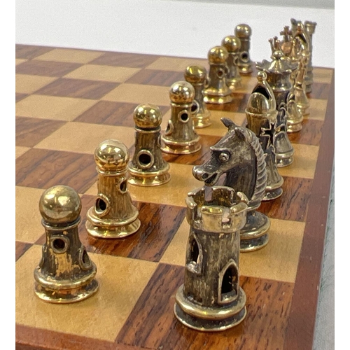 1162 - A cased silver chess set with silver and silver gilt playing pieces and a wooden chessboard. Each pi... 