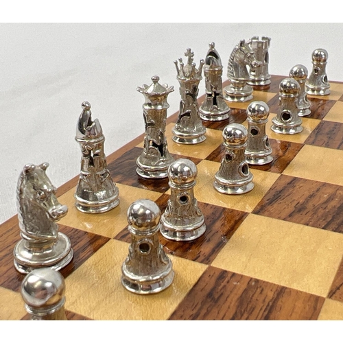 1162 - A cased silver chess set with silver and silver gilt playing pieces and a wooden chessboard. Each pi... 